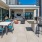 The outdoor lounge at our South Waterfront apartments for rent, featuring a grill station and view of the city.