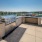The outdoor lounge at our South Waterfront apartments for rent, featuring a grill station and view of the water.