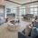Resident lounge at our apartments for rent in Portland, Oregon, featuring wood grain floor paneling and cushioned chairs.